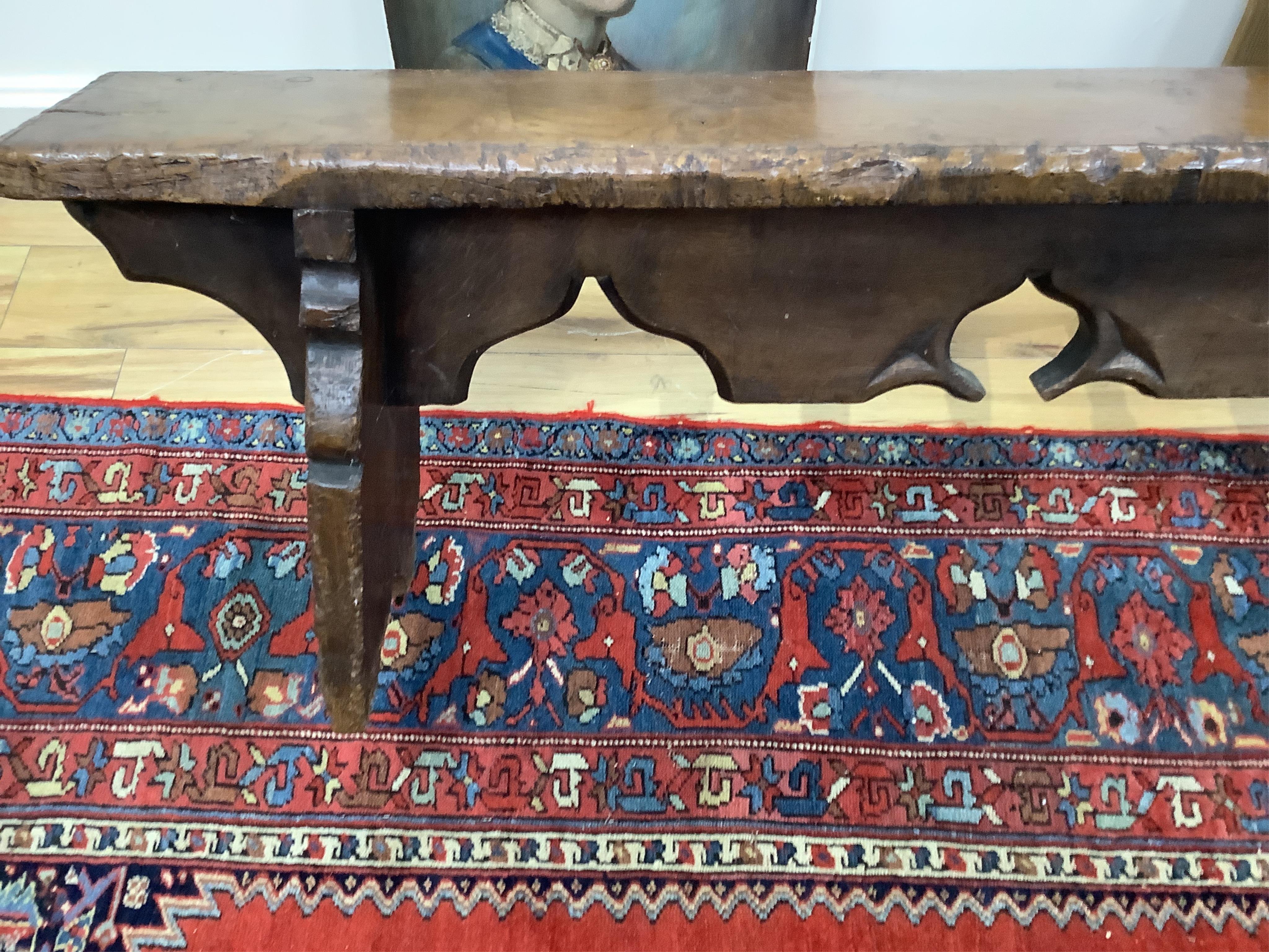 A pair of oak trestle end benches, in Elizabethan style, width 182cm, depth 25cm, height 49cm. Condition - fair, Provenance - made for Brede Place, Brede, Rye, East Sussex. Commissioned from Stuart interiors who have fur